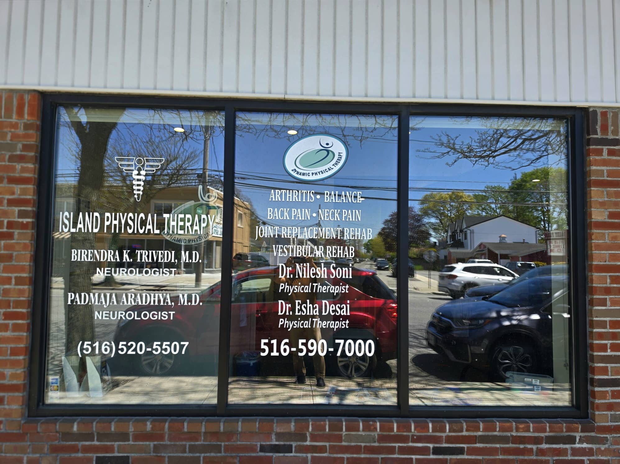 Storefront window of Dynamic Physical Therapy Massapequa with clinician names and services