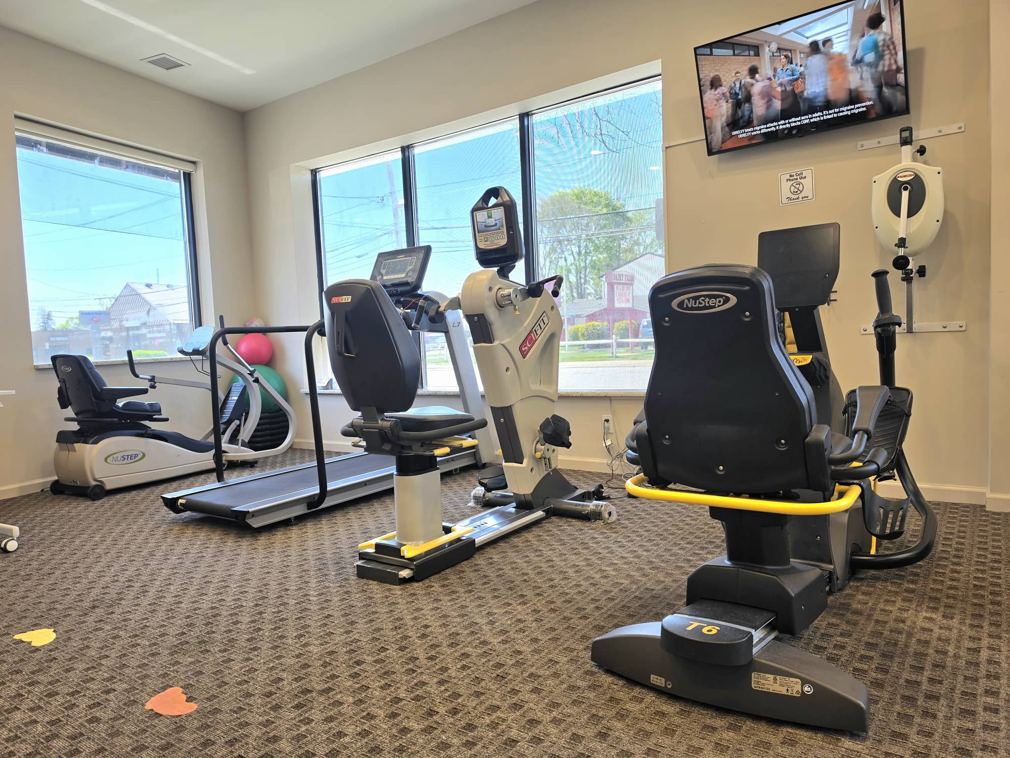 Gym floor at the Massapequa clinic with cardio and rehabilitation equipment